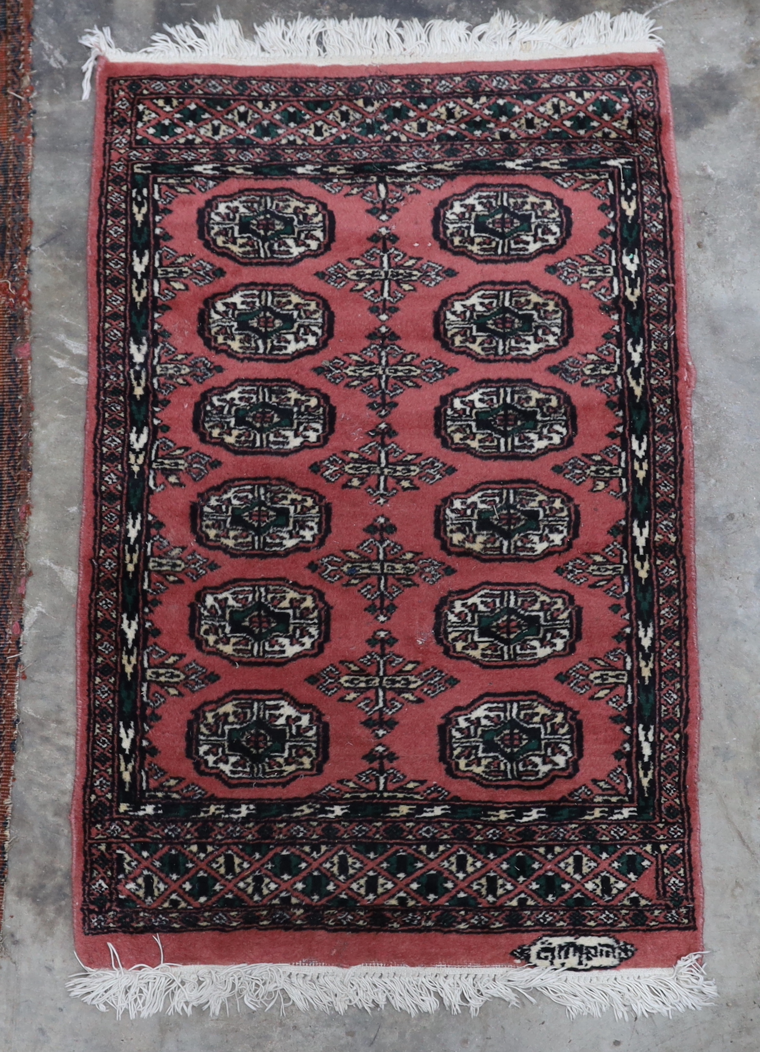 An antique Tekke red ground rug, a Caucasian rug and three others, largest 194 x 138cm